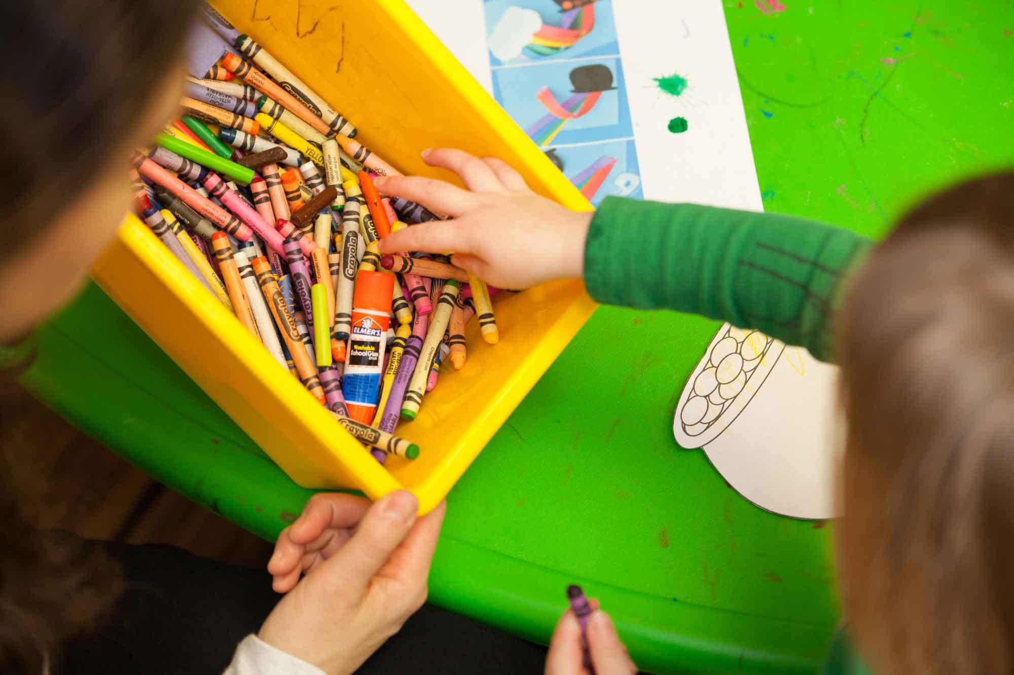 Child grabbing crayons
