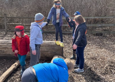 Group of children working together in a team building activity in Outdoor Therapy Camp. Arlington Heights, Rolling Meadows, Palatine, and surrounding areas.